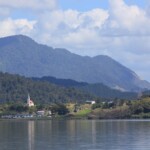 The church from mid-harbour, much closer than when you are eating fission chips on Rawene foreshore